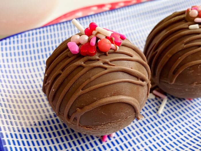 Make your own delicious Hot Cocoa Bombs at home for a tasty Valentine's Day treat! Includes easy step by step directions!