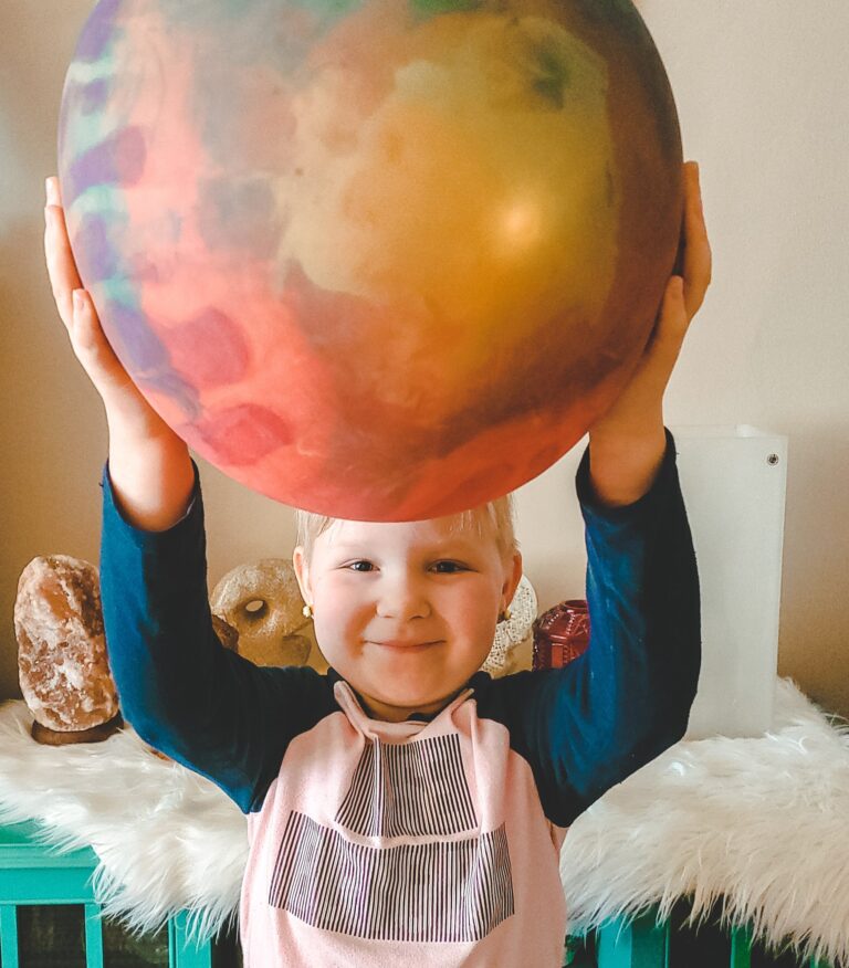 little girl holding up wubble ball