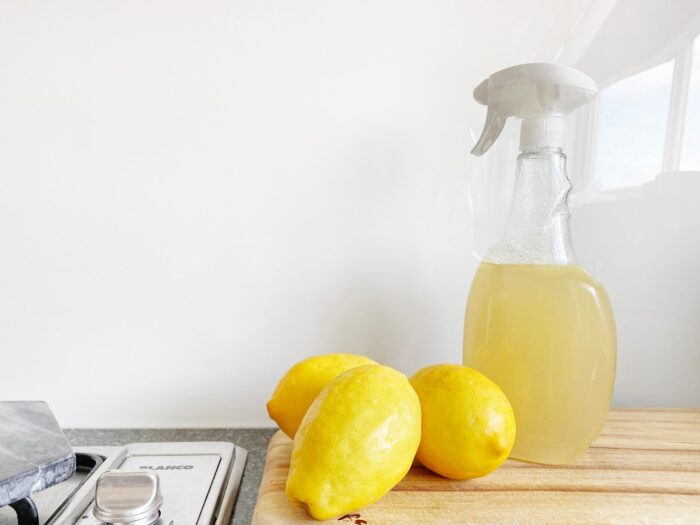cleaning bottle, lemons by a stove