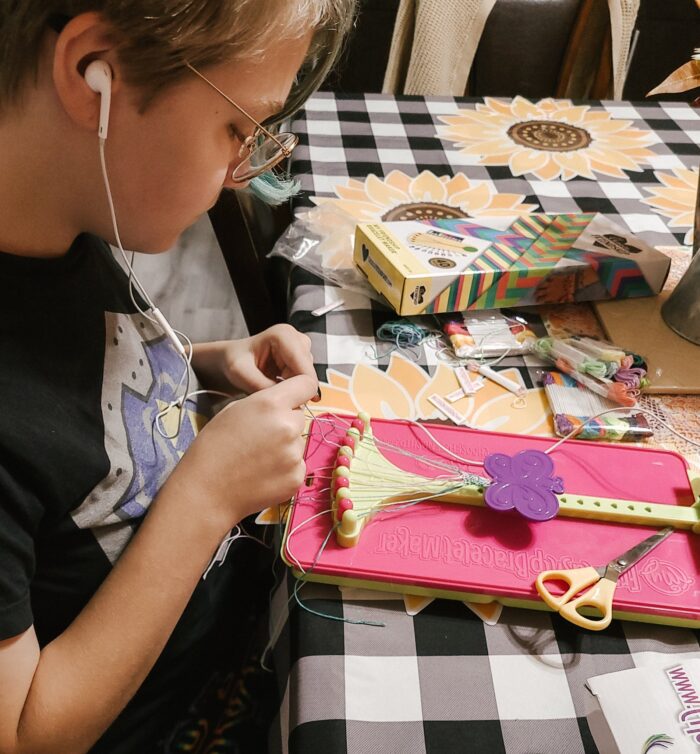 teenager making friendship bracelets with friendship bracelet maker