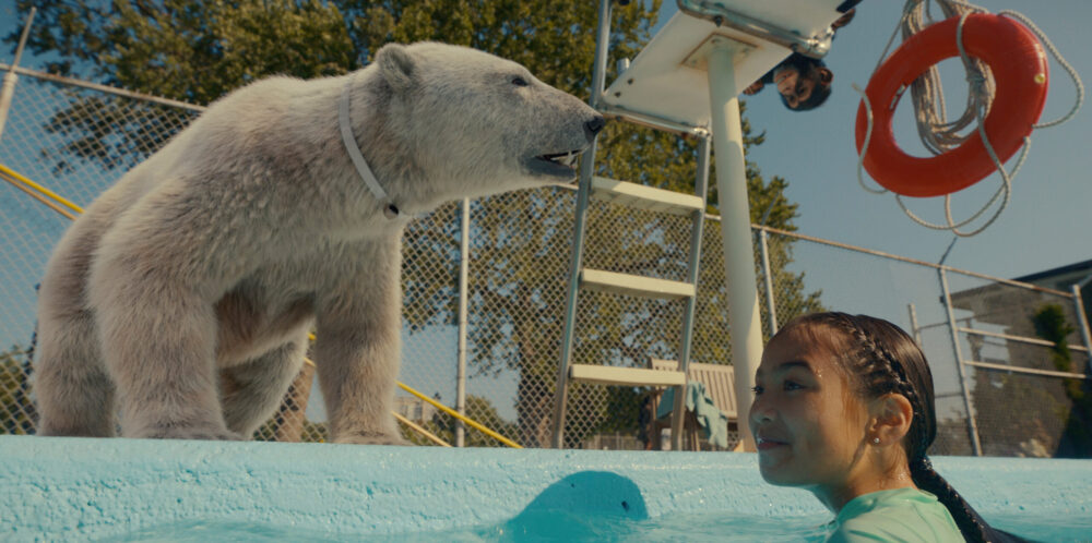 girl and polar bear at a pool