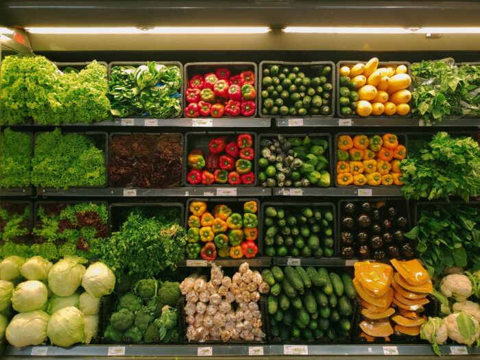 photo of produce at the grocery store for article about 15 ways you can save money on your grocery bill this month. See how you can cut costs and live more frugally.