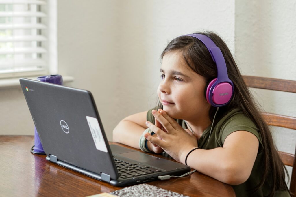 child working online for educational resources for summer enrichment