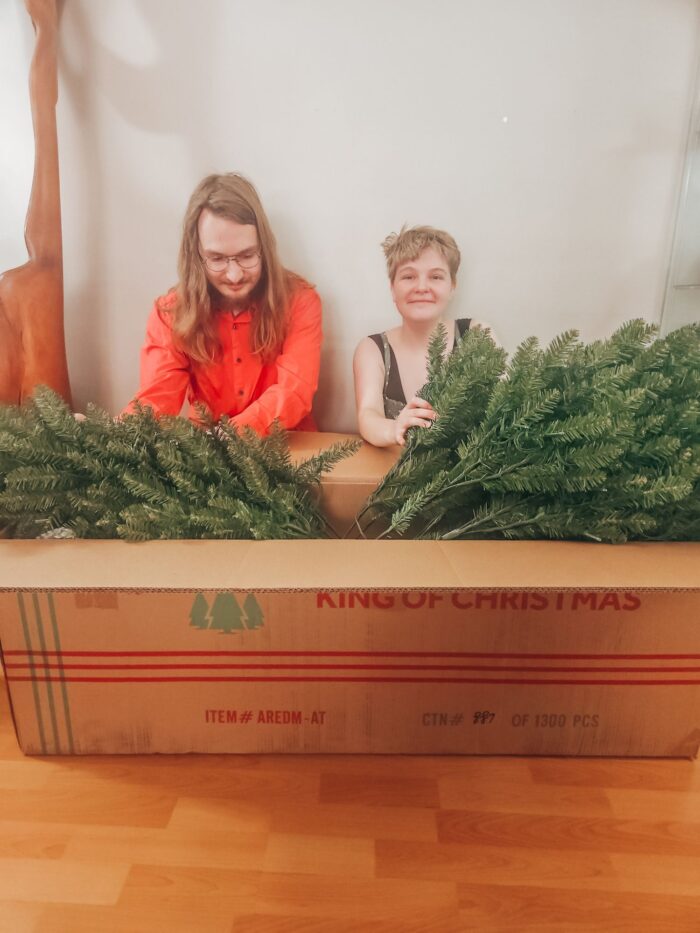 two adults unboxing a King Of Christmas 7.5' Yorkshire Fir Artificial Christmas Tree