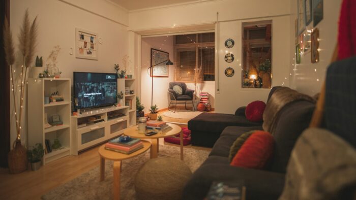 living room with couch and chair and a movie on the tv