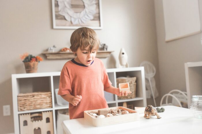 child playing with montessori toys in a play room