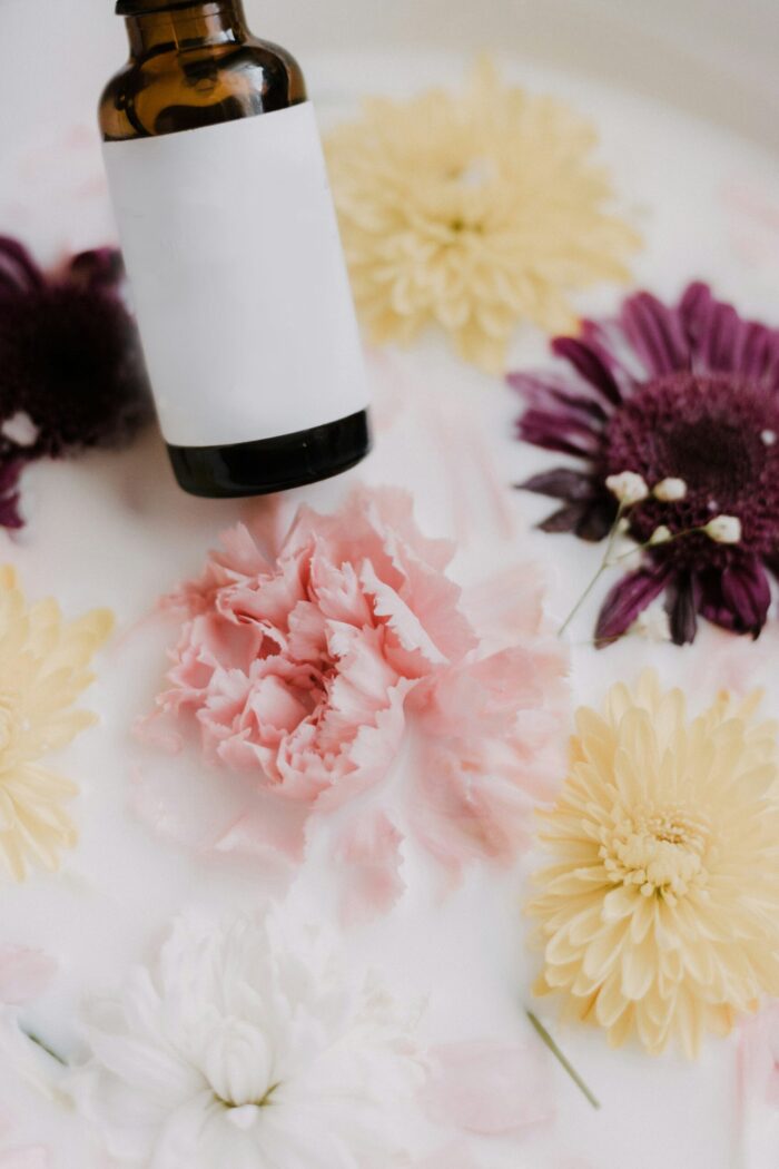 beauty product surrounded by flowers