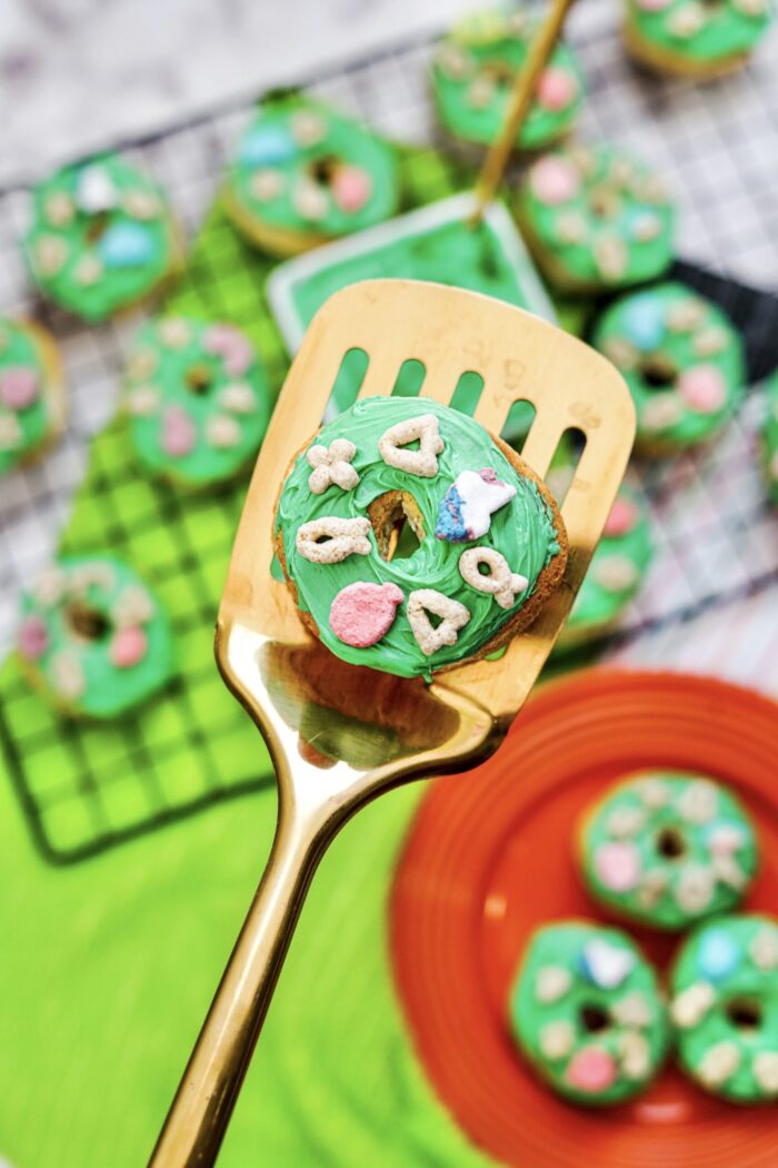 St. Patrick's Day Air Fryer Lucky Charms Donuts on a spatula