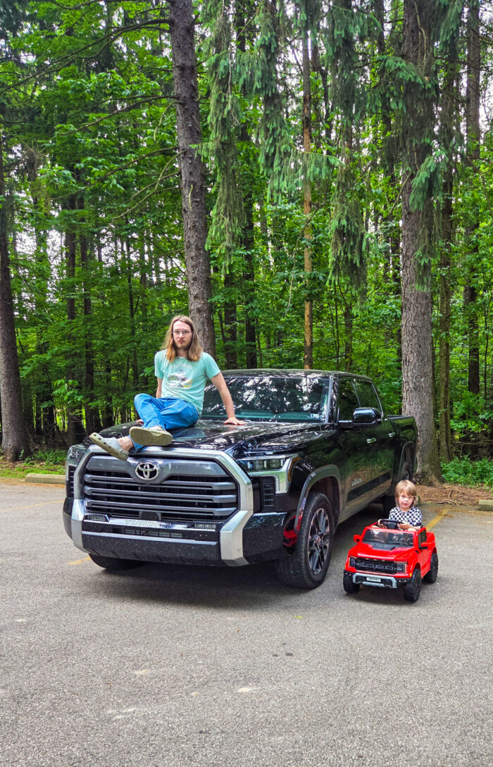 an adult and child with their trucks