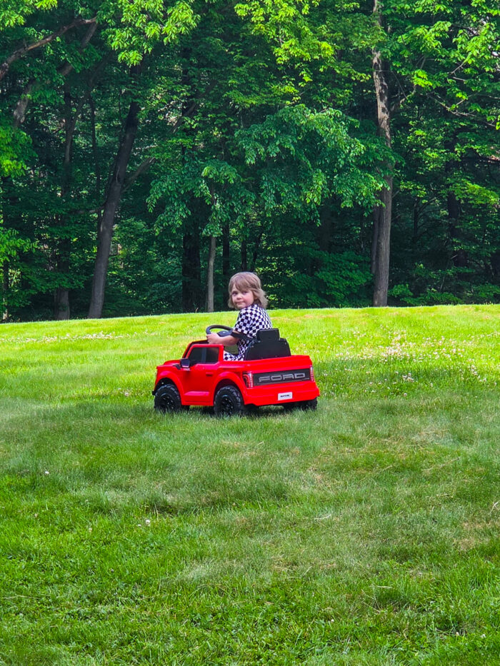 Little boy riding in an electric kids vehicle